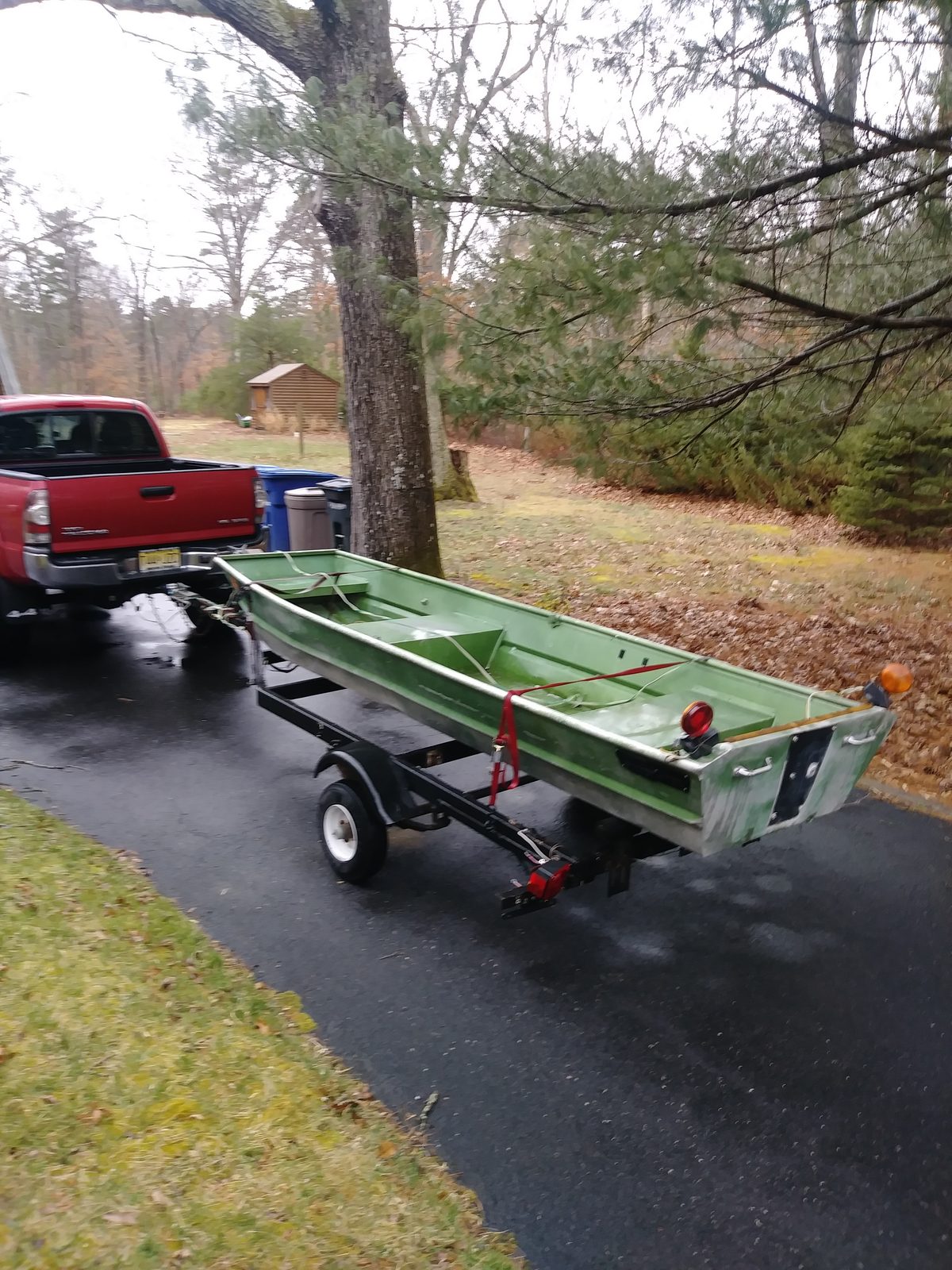 Weathered hull as bought, sitting on its trailer with the truck in the driveway